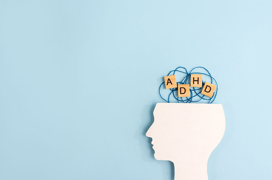 Graphic of white head with squiggles and ADHD letters