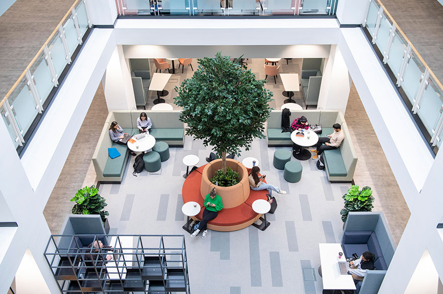 Birds eye view of students sitting in the new postgraduate centre