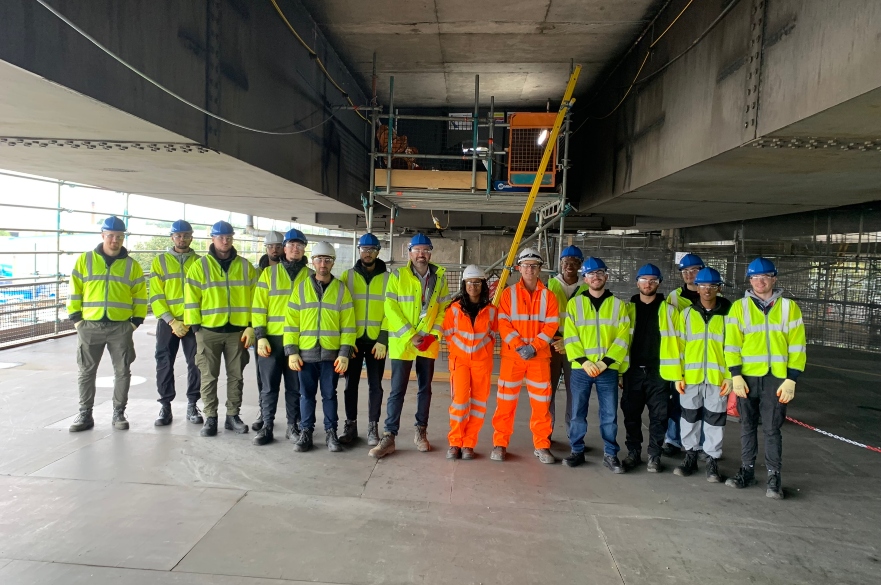 Students on site in PPE smiling at camera
