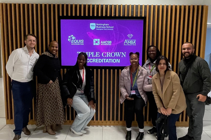 GEMBA cohort standing inside of the Newton building.