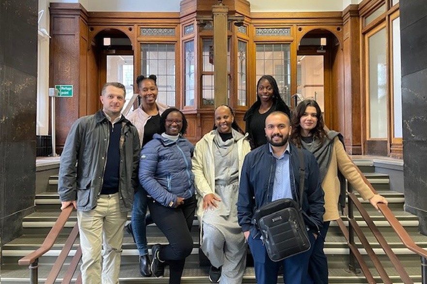 NBS GEMBA cohort stood smiling.