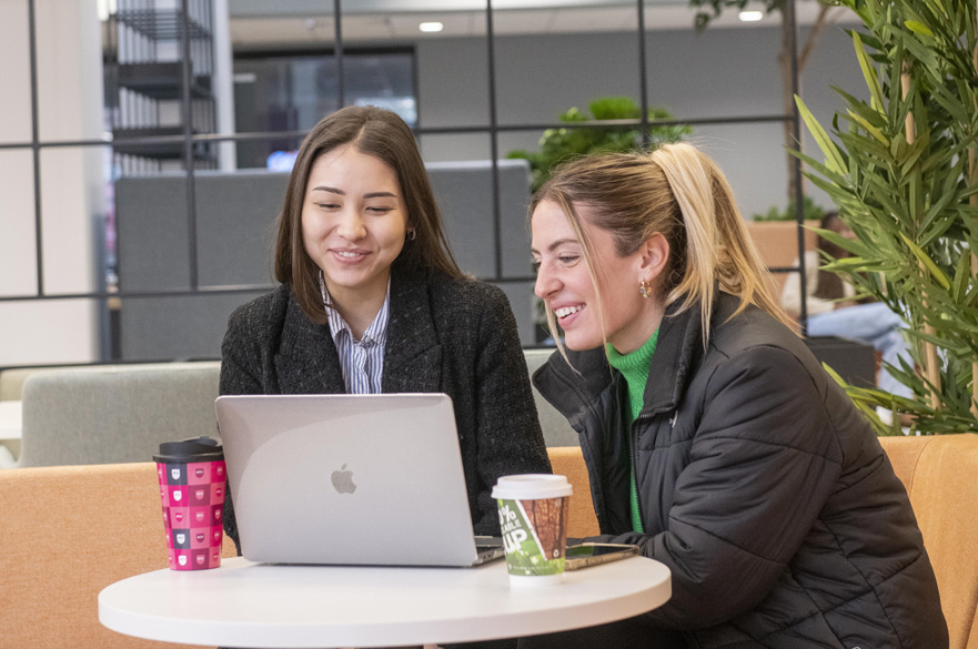 Students working together on a laptop.