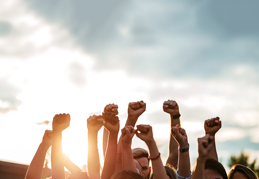 Group of people with fists in the air 