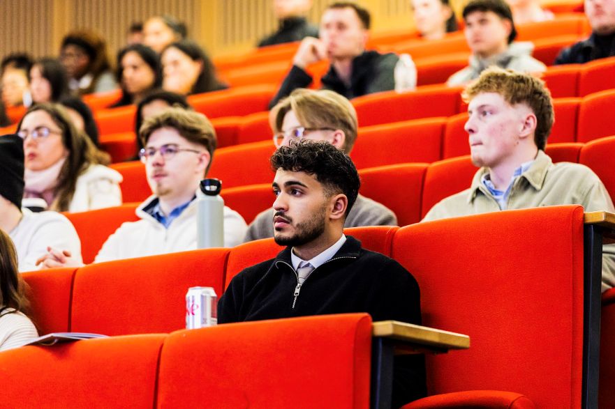 A group of students in a lecture theatre attending a presentation