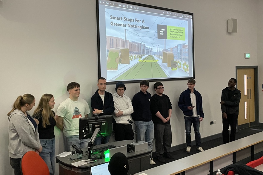 A group of students presenting in front of a screen.