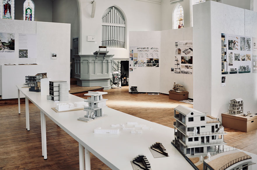 Architecture designs and mock-ups displayed inside of a church
