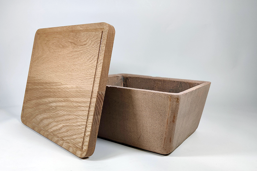 Terracotta food container with vegetables in it