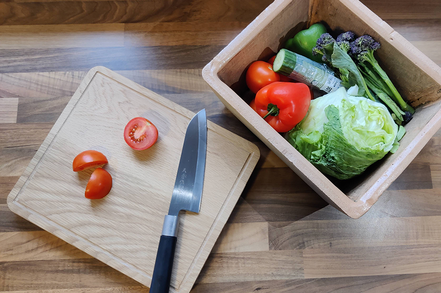 Terracotta food container with vegetables in it