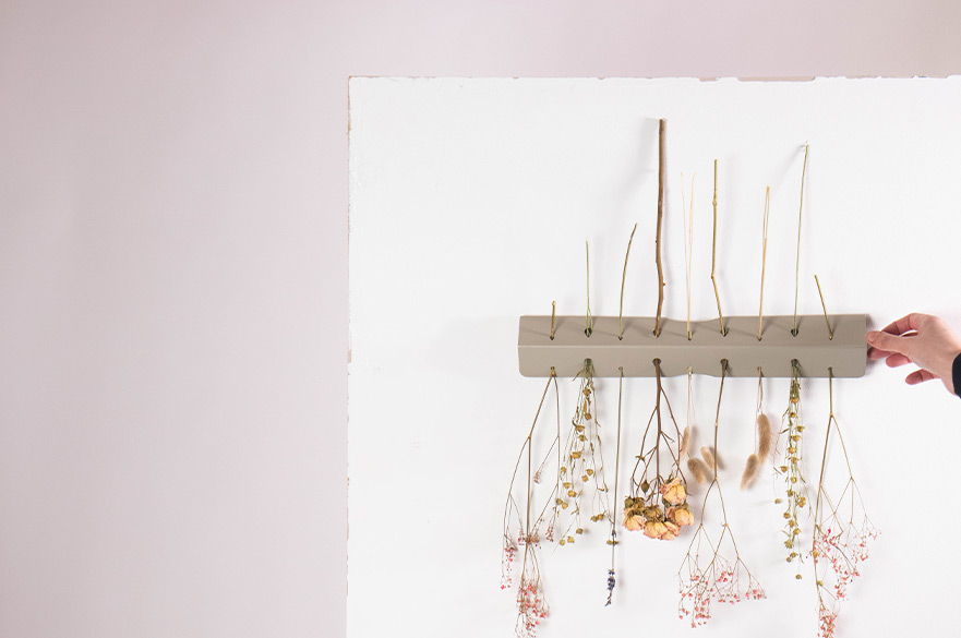 Hand placing flowers on a wooder project