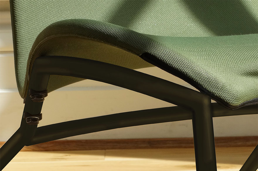 Green and wooden lounge chair displayed next to a tall window with the sun shining through