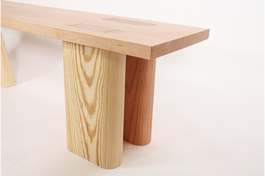 A wooden bench with a pink background