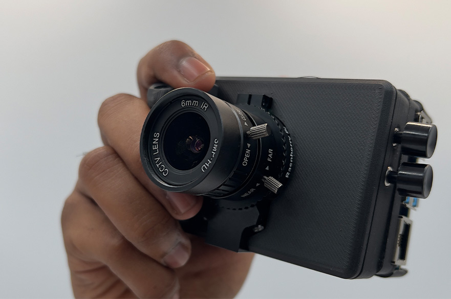A hand holding up a camera