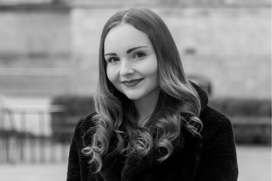 Black and white photo of a person facing the camera.