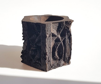 A small pot that has been made out of repurposed coffee grounds.