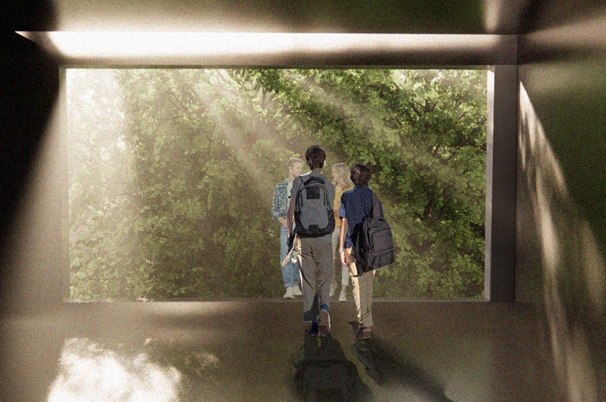 The interior of a building. Two people are looking out of a large glass window on to a wall of green tree foliage.