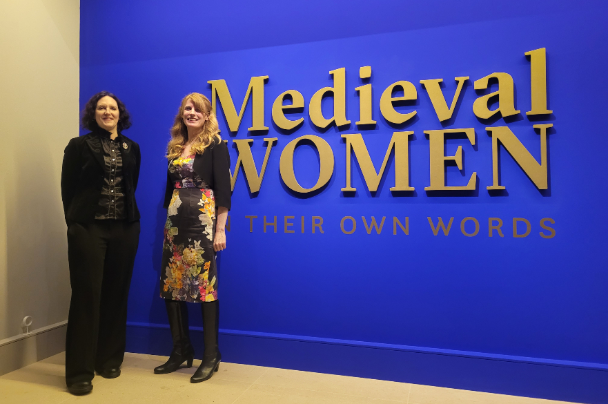 NatashaHodgson and Kate Arnold standing next to the exhibition sign