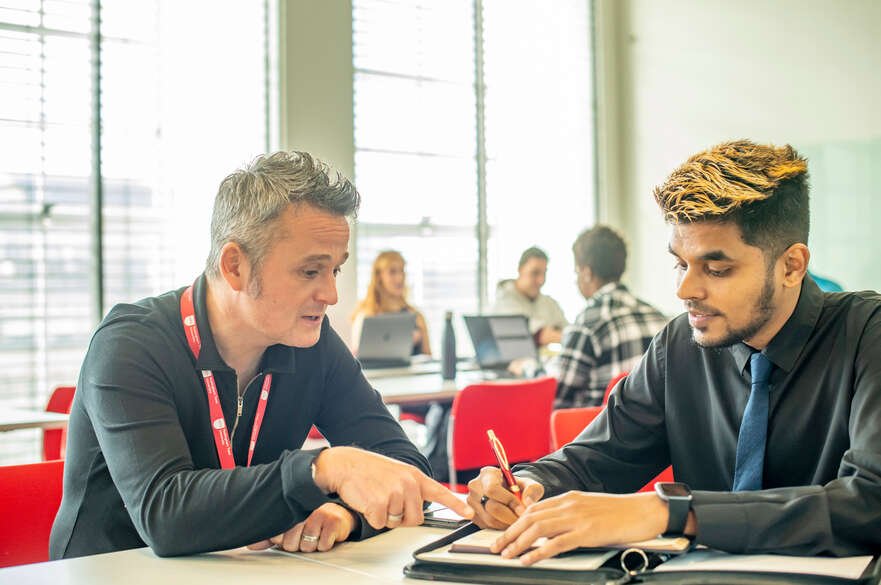 Student and tutor at a desk