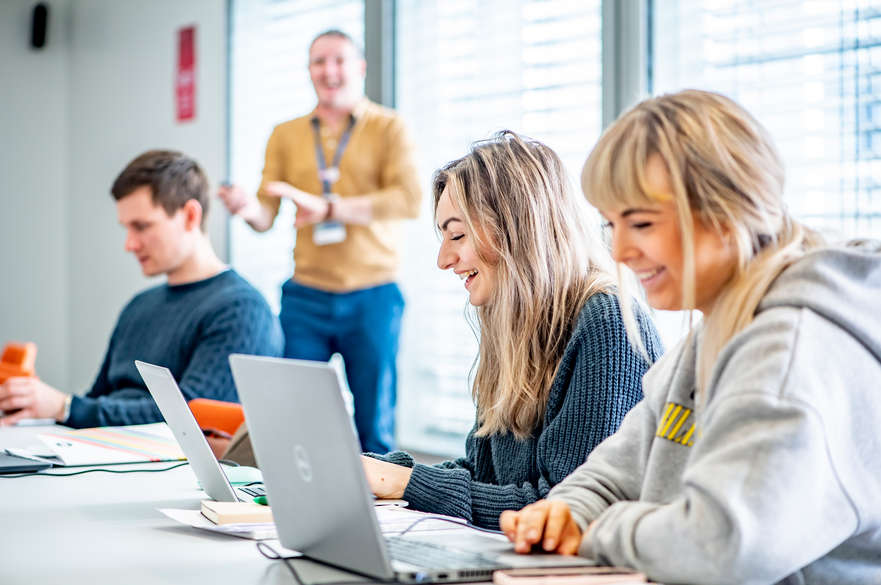 students smiling working in seminar