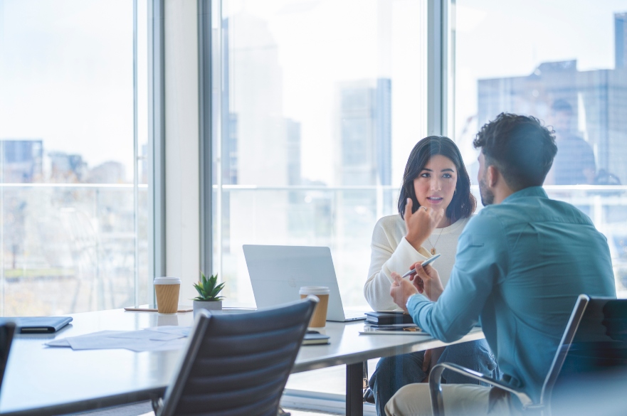 two people talking sat at a table