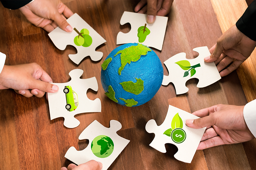 World surrounding by puzzle pieces with images on representing sustainability
