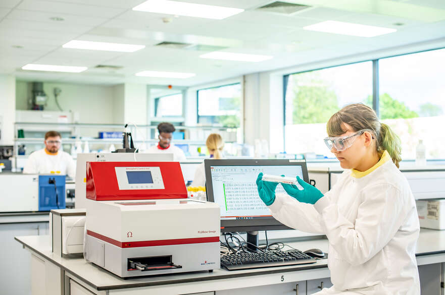 Pharmacology student using lab equipment