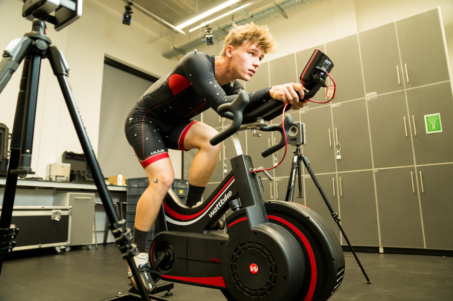 Student on an ergobike wearing suit that takes performance measurments