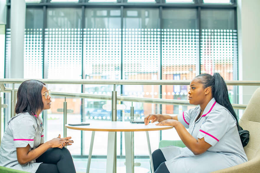 Two nursing students in conversation in the HAP Centre at Clifton Campus