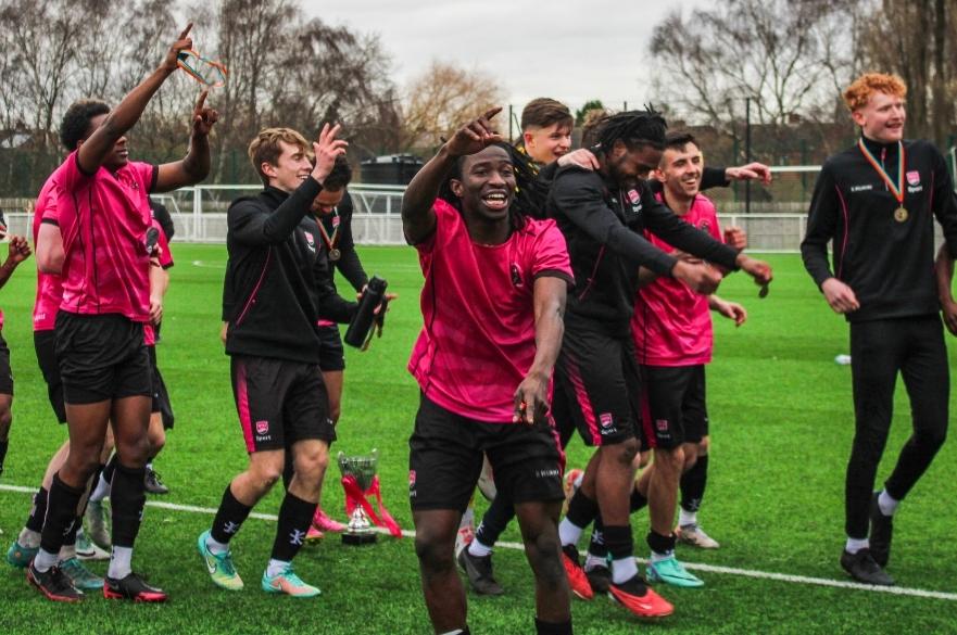 the men's football team celebrating together