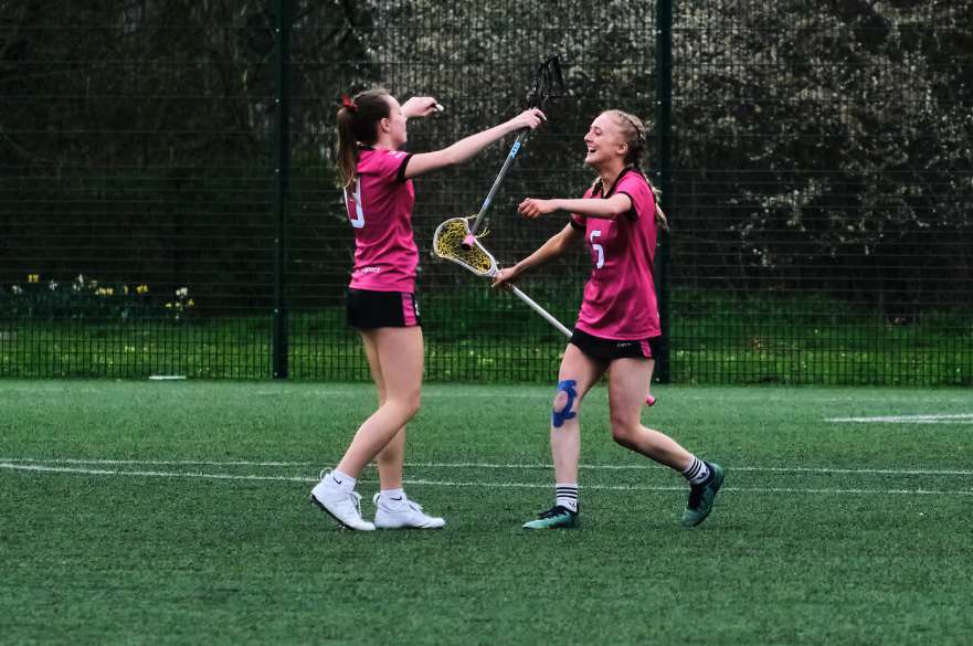 Two NTU Women's Lacrosse players celebrating