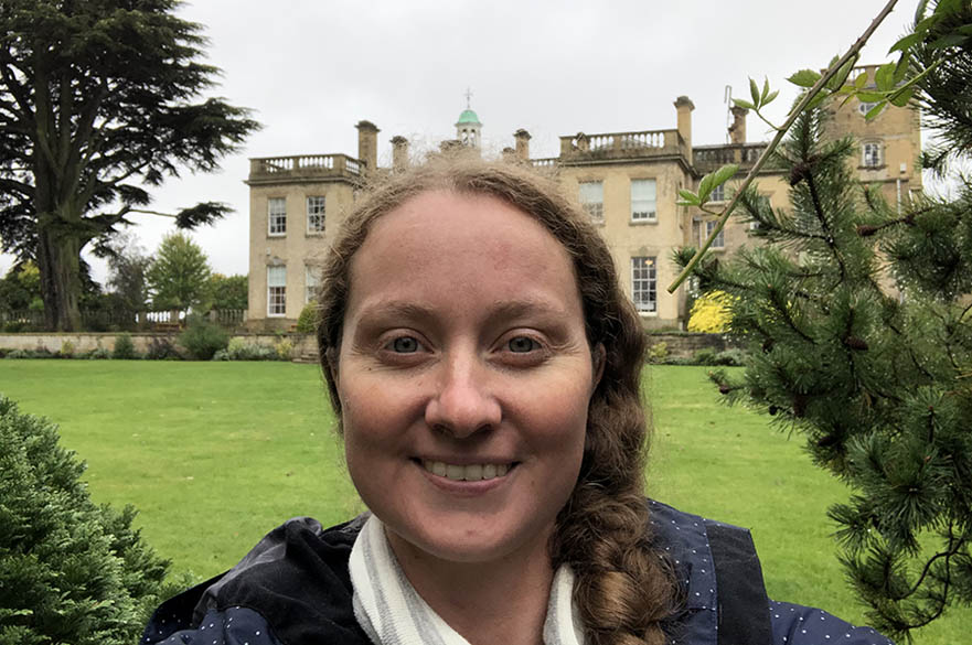 Staff member in front of main hall