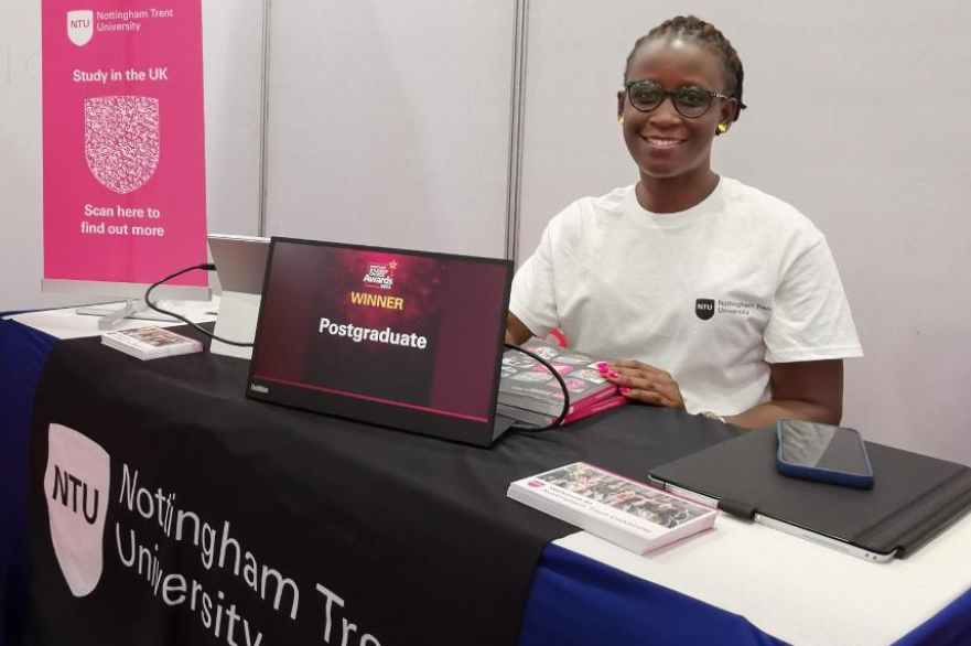 Edel standing with an NTU stand