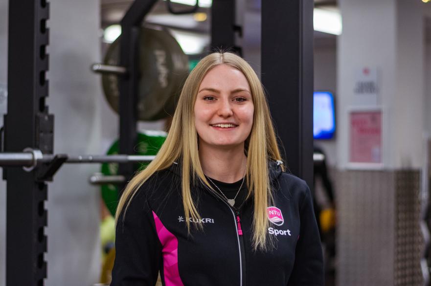 A picture of NTU Sport Fitness instructor, Bella, smiling in the gym