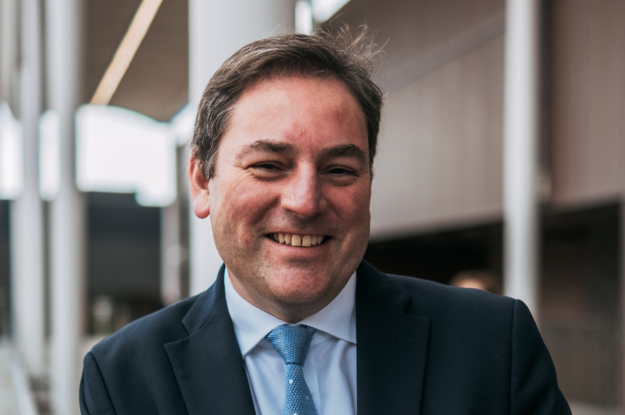 A photo of Richard Emes smiling at the camera.