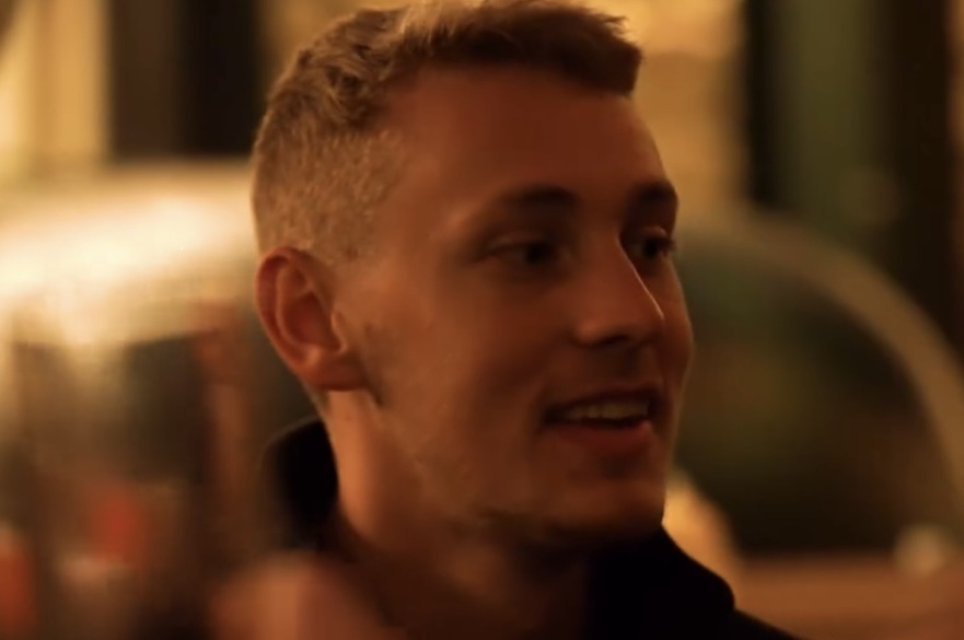 A student smiling into camera