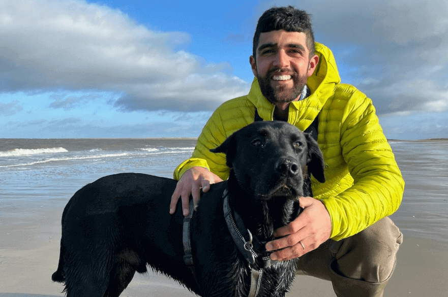 Photo of Ajay Tegala with a black dog