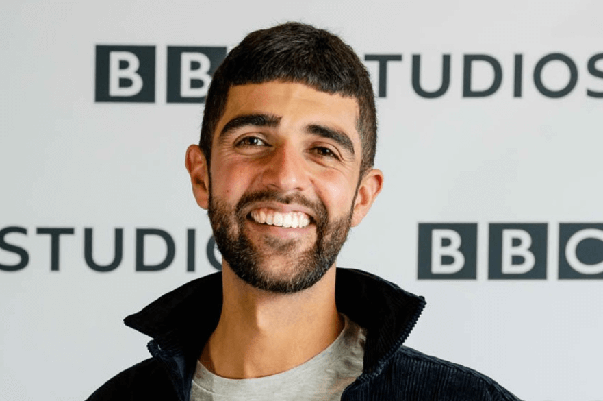 Photo of Ajay Tegala in front of a BBC sign