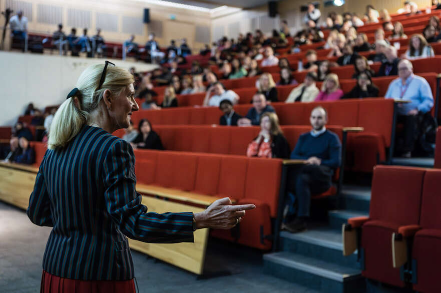 Lecturer speaking in a large lecture theater