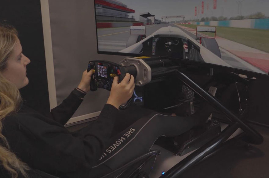 A female student driving the motorsport simulator