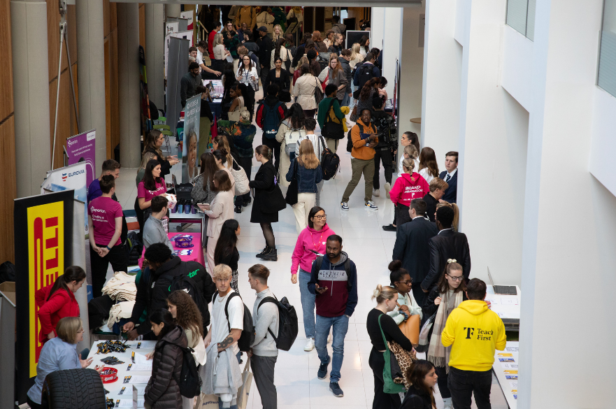 Students walking around a careers fair in Newton building