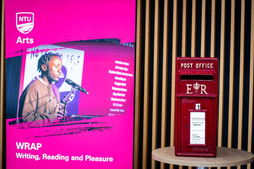 A post box and NTU Arts promotional stand