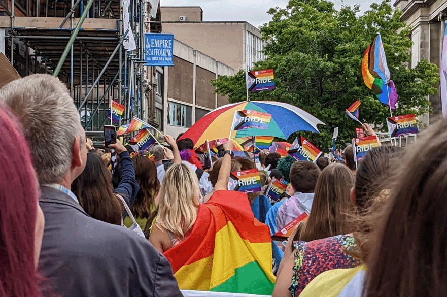 A group of people walking along with Pride flags at Nottinghamshire Pride 2022
