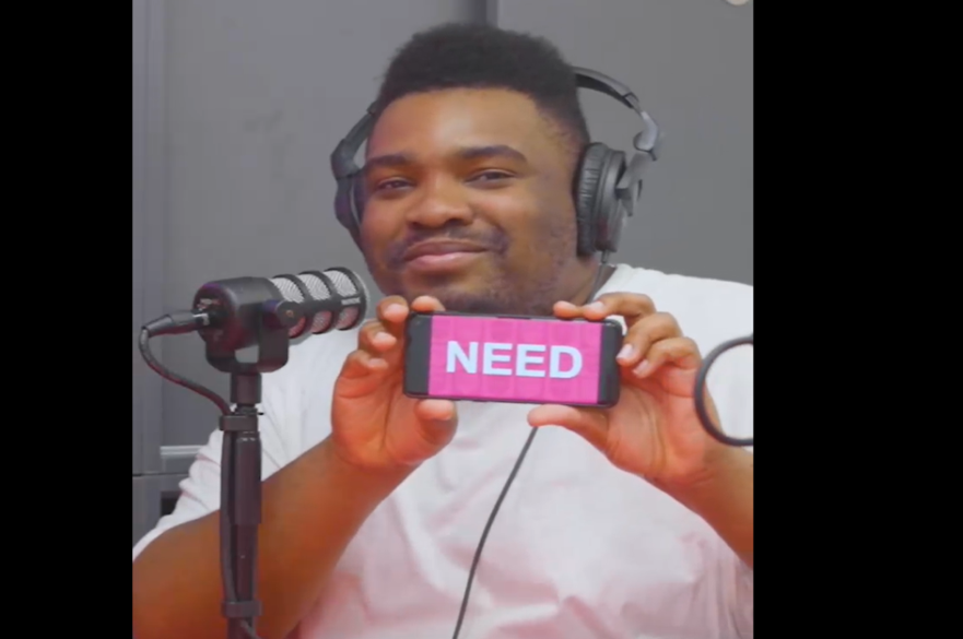 Man with phone screen that says 'need'