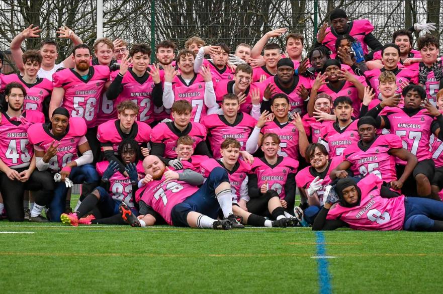 a picture of the american football team posing after a victory to secure the league title