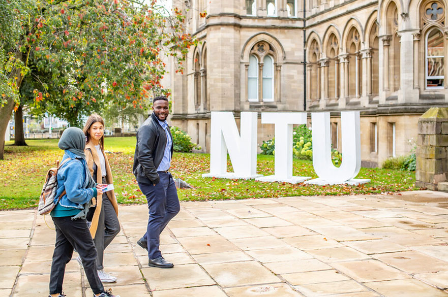 Students walking in front of the NTU letters at the entrance to Arkwright
